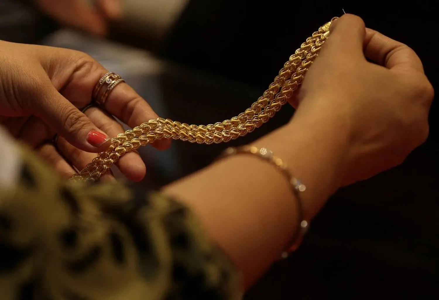 A customer holds a gold chain at a jewellery store in Mumbai, India, January 30, 2026. (Reuters)