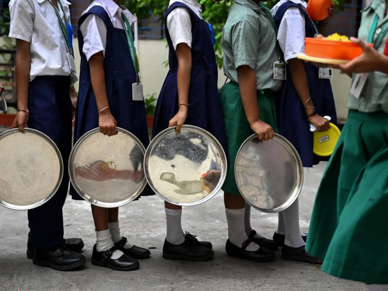 Students queue to receive lunch at a government-run primary school in Kolkata, India. Dibyangshu SARKAR / AFP
