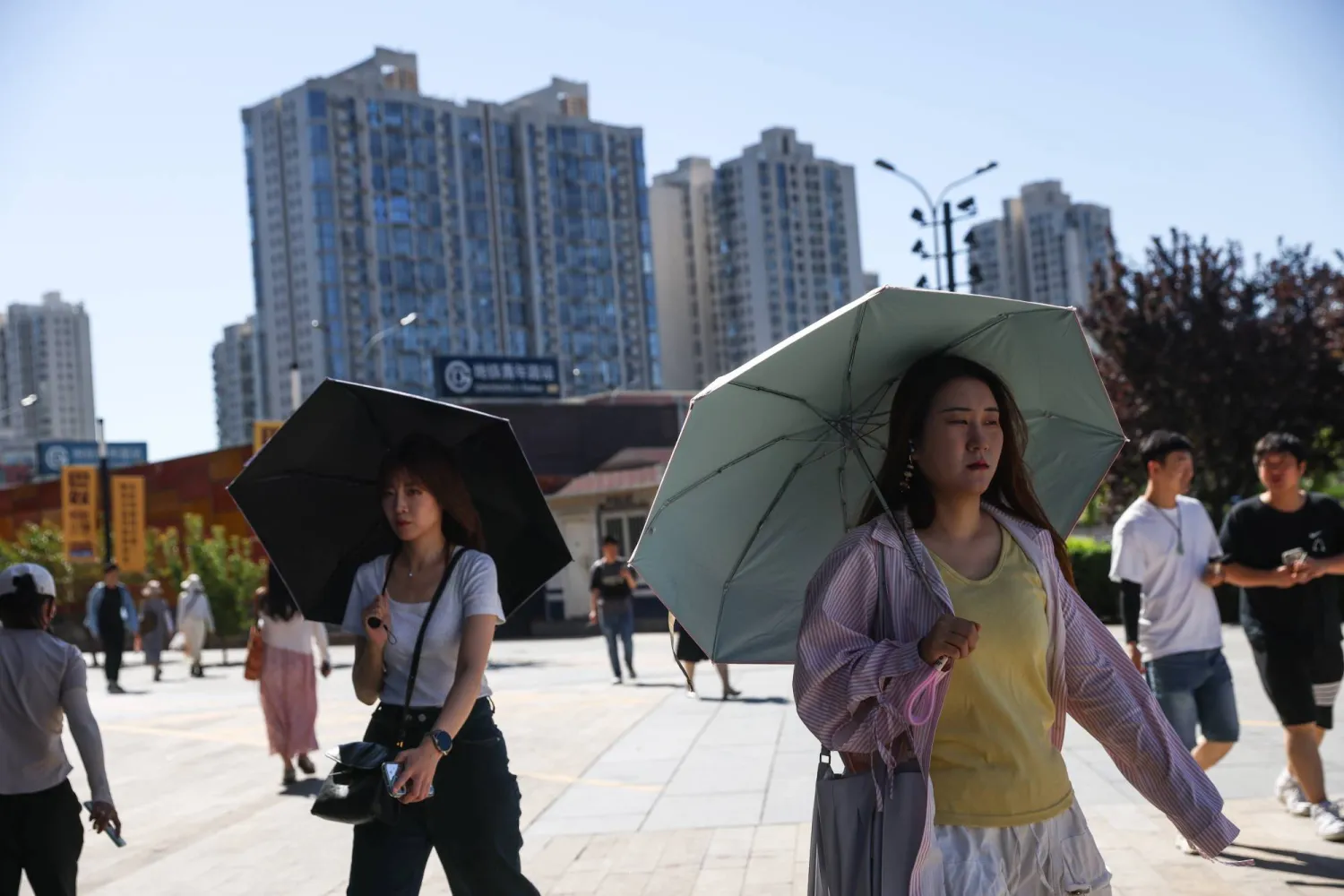 People walk in the Central Business District (CBD) area in Beijing, China, 15 July 2026. EPA/WU HAO