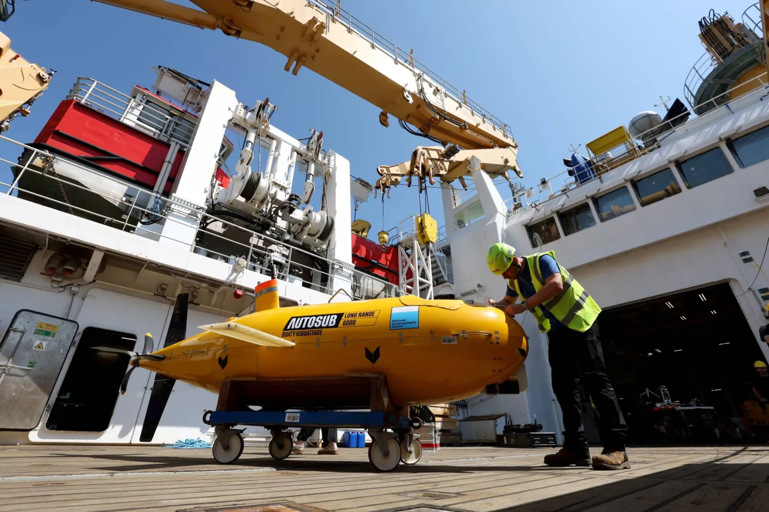 Sam Smith, an Operations Engineer, alongside Auto Sub Boaty McBoatface aboard the RRS Sir David Attenborough ahead of a mission to Greenland to study how warming affects the ice sheet and improve forecasts of its impact on the Atlantic, in Harwich, Britain, July 14, 2026. REUTERS/Chris Radburn