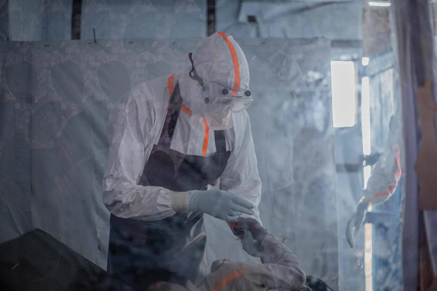 A doctor provides care to a patient with Ebola virus disease at the Rwampara Ebola Treatment Centre (ETC) in Bunia, Ituri, in the east of the Democratic Republic of Congo on July 13, 2026. (Photo by BENEDICTION MURHABAZI / AFP)