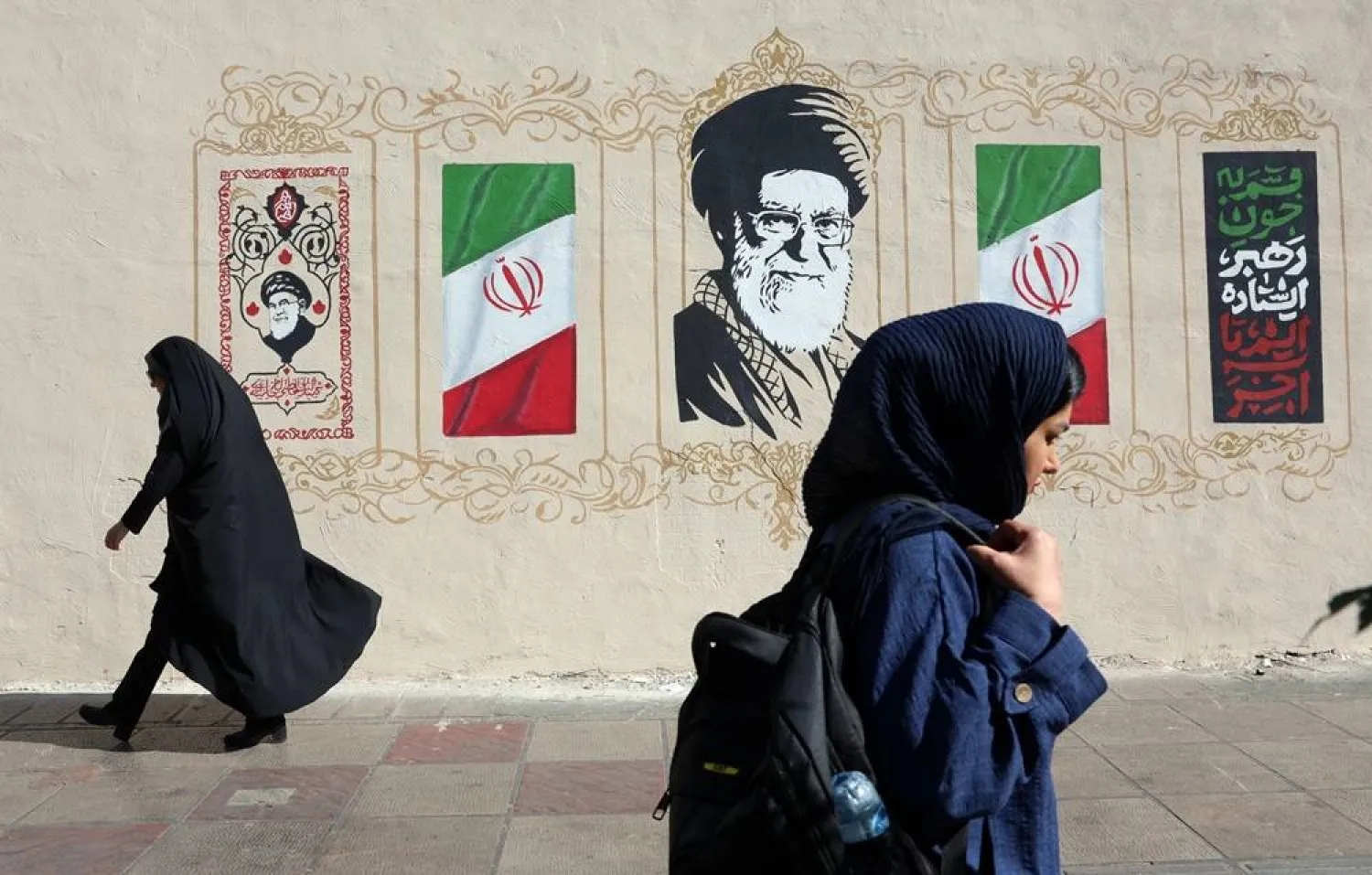 Iranian women walk past a mural of late Iranian Supreme Leader Ali Khamenei on a street in Tehran, Iran, 15 July 2026. (EPA) 