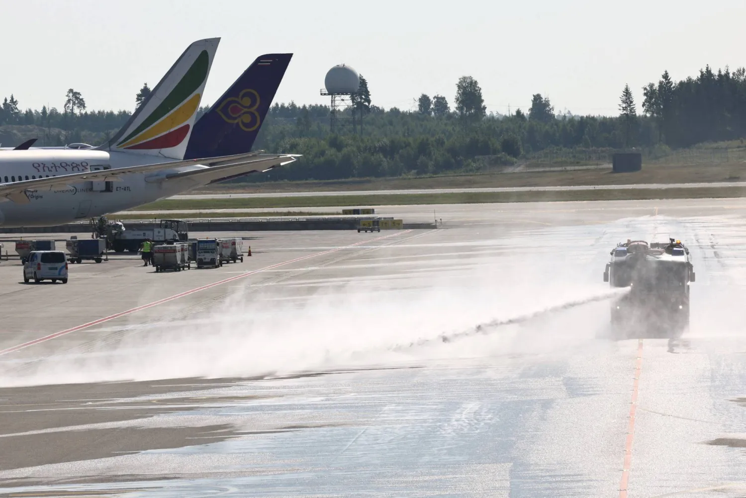 A vehicle from Oslo Airport’s fire rescue services sprays water onto the runway at the airport, to combat heat, in Oslo, Norway, July 15, 2026. REUTERS/Tom Little