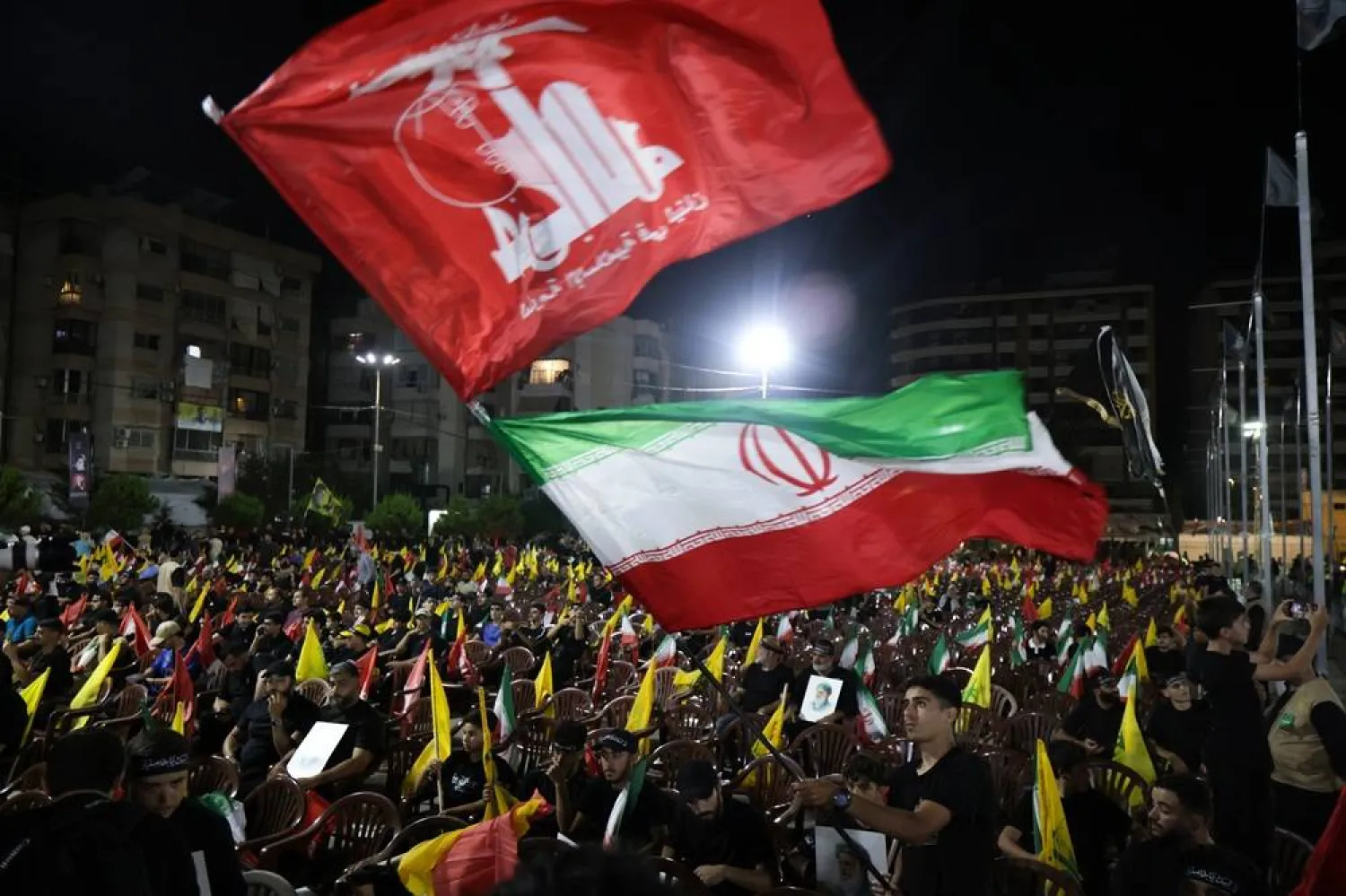 Supporters of Hezbollah carry Iranian and Hezbollah flags during a memorial ceremony for slain Supreme Leader Ali Khamenei in the southern suburbs of Beirut, Lebanon, 08 July 2026. (EPA)