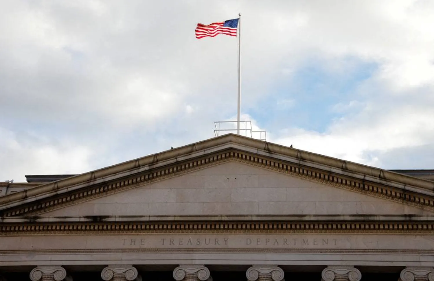 The American flag flies over the US Treasury building in Washington, US, January 20, 2023. (Reuters)
