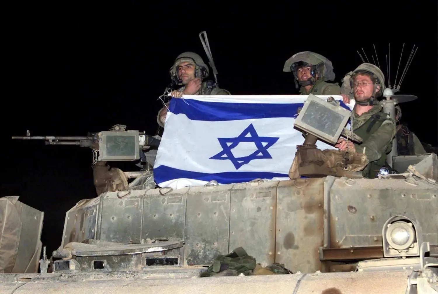 Israeli soldiers aboard an armored vehicle along the Lebanon border (file photo – Reuters) 