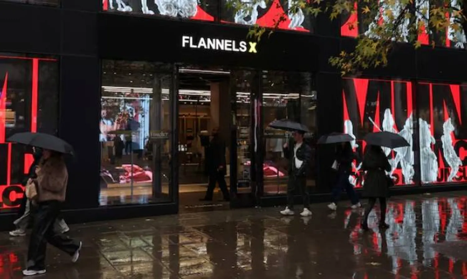 People walk past a Flannels store in London, Britain, December 4, 2025. REUTERS/Hannah McKay