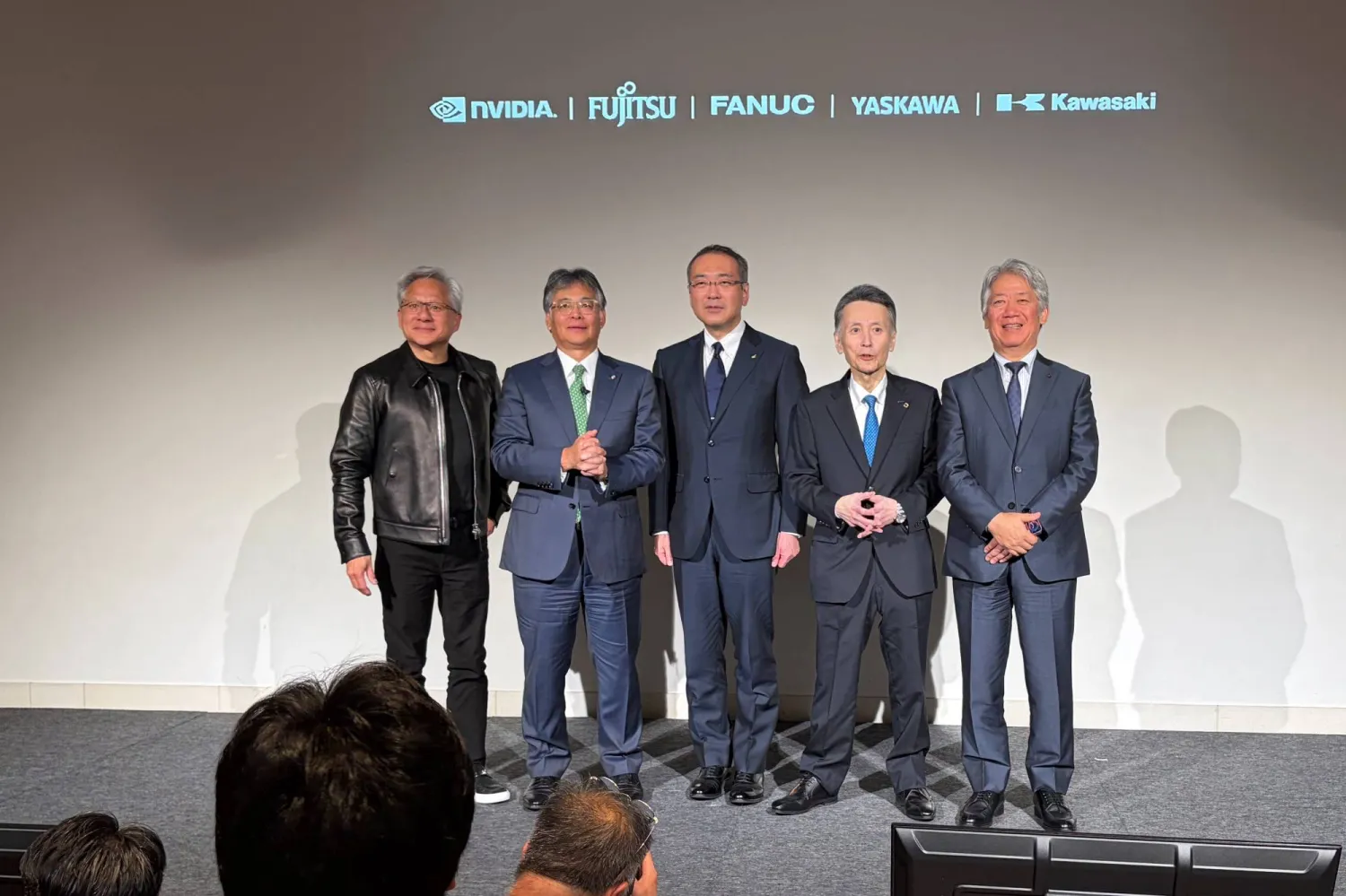From left, Nvidia CEO Jensen Huang, Fujitsu CEO Takahito Tokita, Fanuc CEO Kenji Yamaguchi, Yaskawa CEO Masahiro Ogawa and Kawasaki Heavy CEO Yasuhiko Hashimoto pose for the media at an event to announce a new initiative in Tokyo, Thursday, July 16, 2026. (AP Photo/Yuri Kageyama)