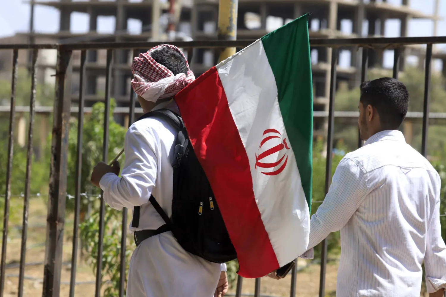 A Yemeni holds an Iranian flag during a rally in Sanaa, Yemen, 15 July 2026. EPA/YAHYA ARHAB