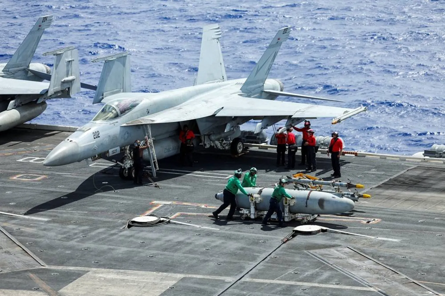  Flight deck crew move a fuel tank from an F-18 fighter jet onboard the USS Theodore Roosevelt as the aircraft carrier participates in Rim of the Pacific (RIMPAC) military exercises in waters south of the Hawaiian Islands, US, July 13, 2026. (Reuters)