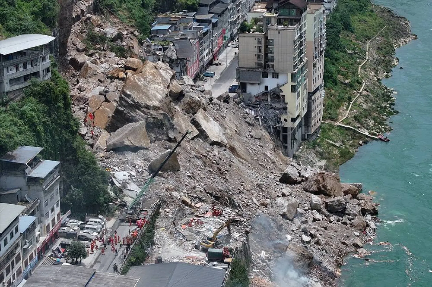  In this photo released by Xinhua News Agency, rescuers conduct search and rescue operation on the site of the landslide in Pengshui County in southwestern China's Chongqing on Friday, July 17, 2026. (Xinhua via AP) 