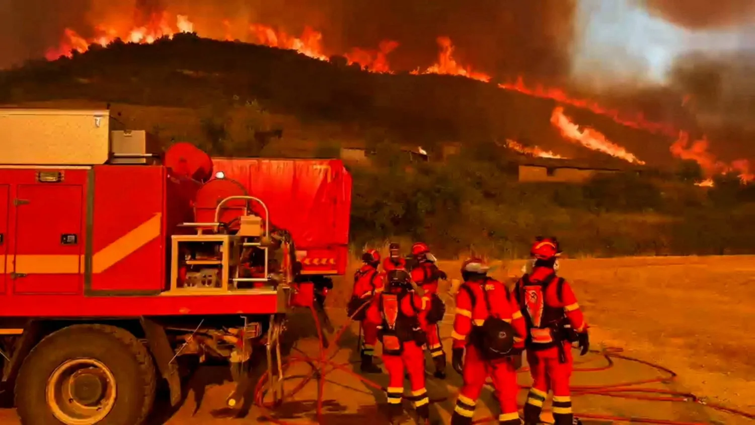 Firefighters work at a site, following a wildfire in the municipality of Ores, northern Aragon region, Spain July 15, 2026, in this screengrab obtained from a video. (Spanish Military Emergency Unit/Handout via Reuters)