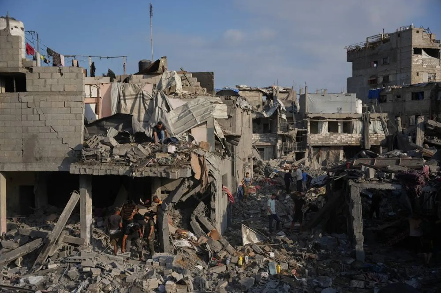 Palestinian residents save their belongings from destroyed buildings following an Israeli airstrike last night, at al-Bureij refugee camp, central Gaza Strip, Thursday, July 16, 2026. (AP)