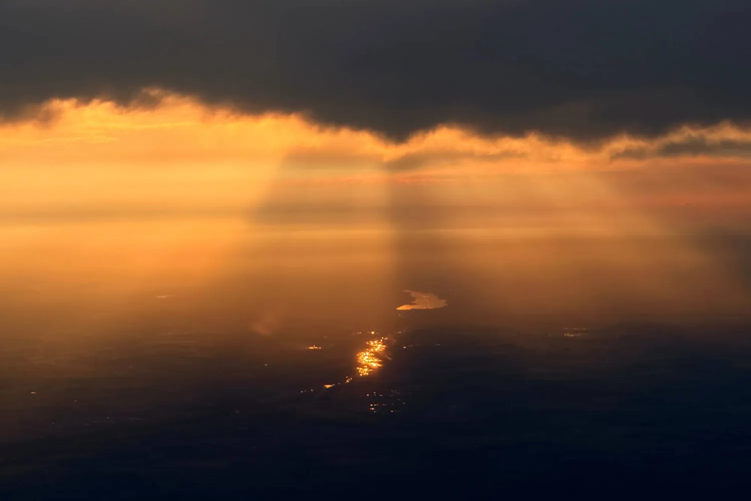 Light reflects off the water as the sun sets through wildfire smoke over Edmonton, Alberta, Friday, July 17, 2026. (AP Photo/Andy Bao)