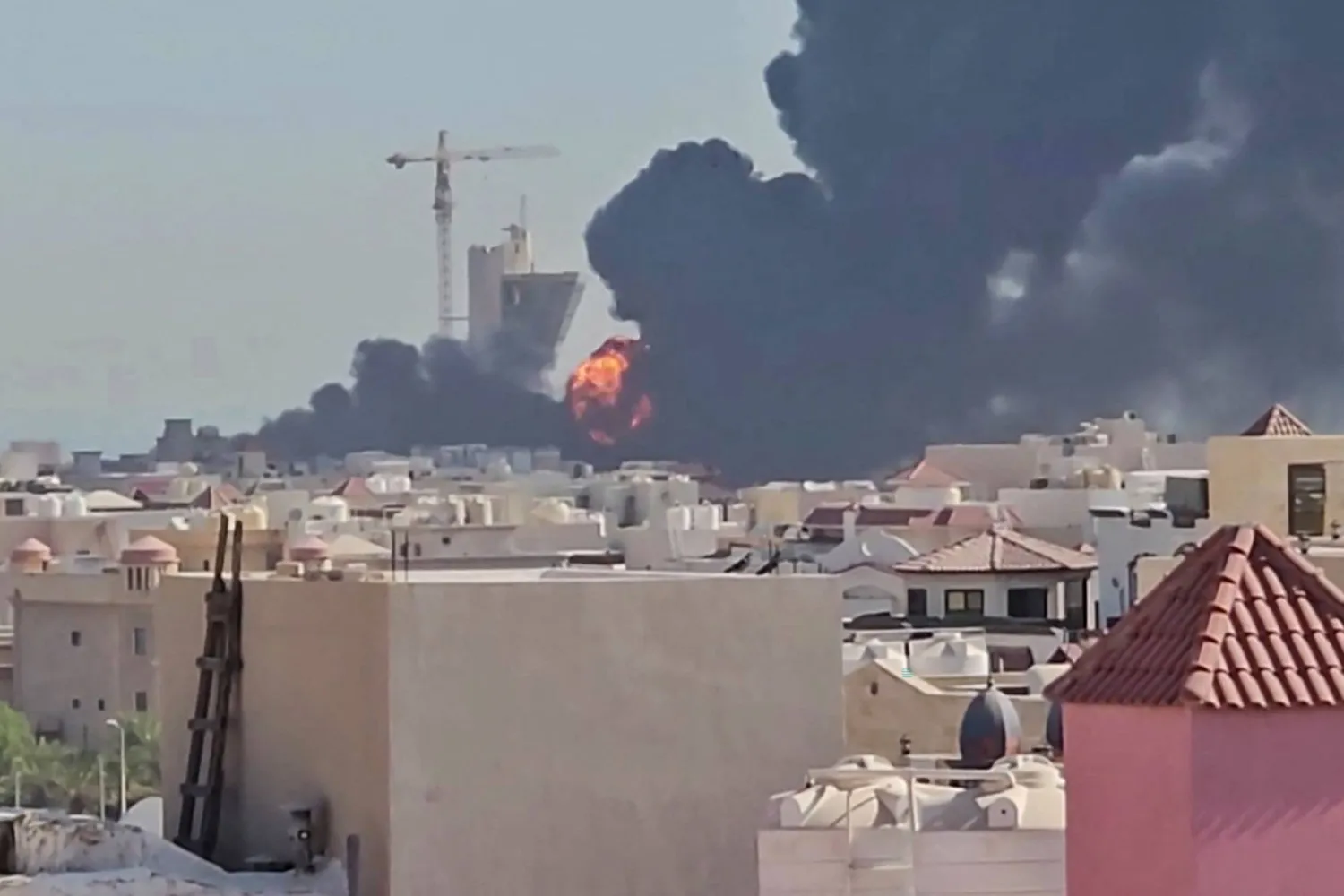 This screen grab taken from UGC video footage posted on social media on July 18, 2026, shows a plume of black smoke and flames billowing over the town of Mangaf, south of Kuwait City. (Photo by various sources / AFP) 