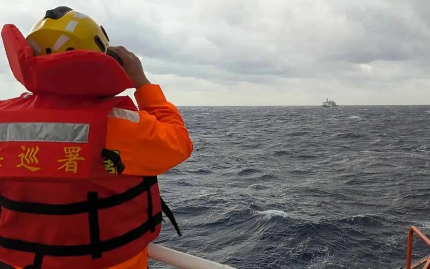 A crew member on board a Taiwan Coast Guard ship monitors a Chinese Coast Guard vessel in waters east of Taiwan. (AFP file) 