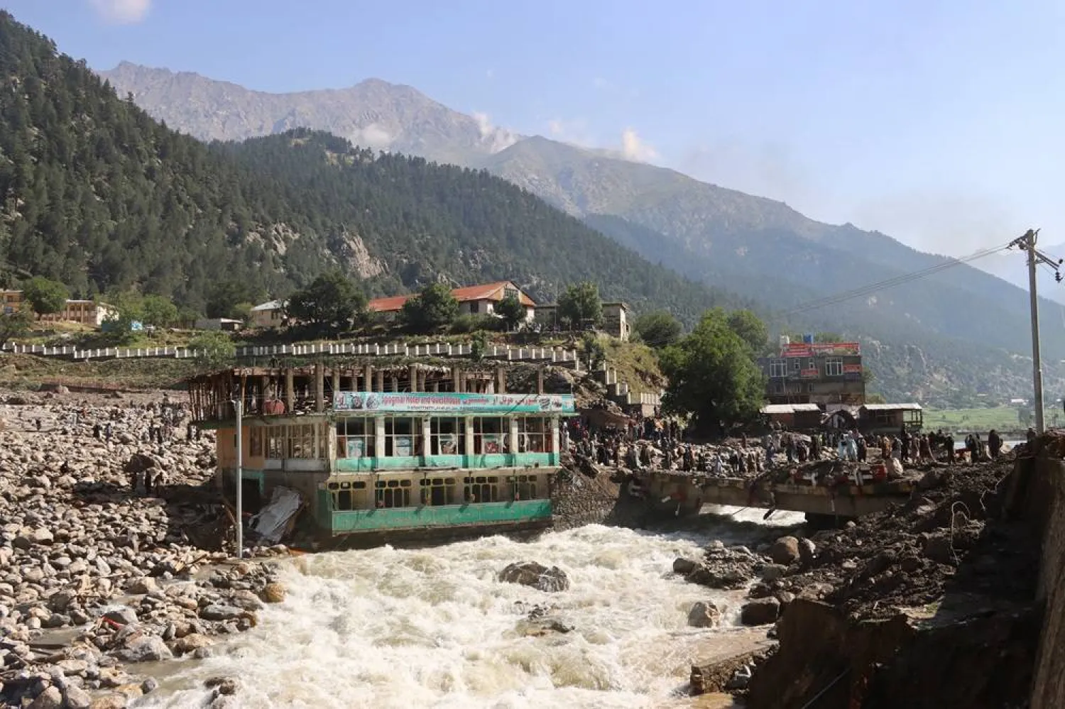 Floodwaters near a hotel and guest house building in Parun, the capital of Nuristan province, Afghanistan, July 21, 2026. (Reuters) 