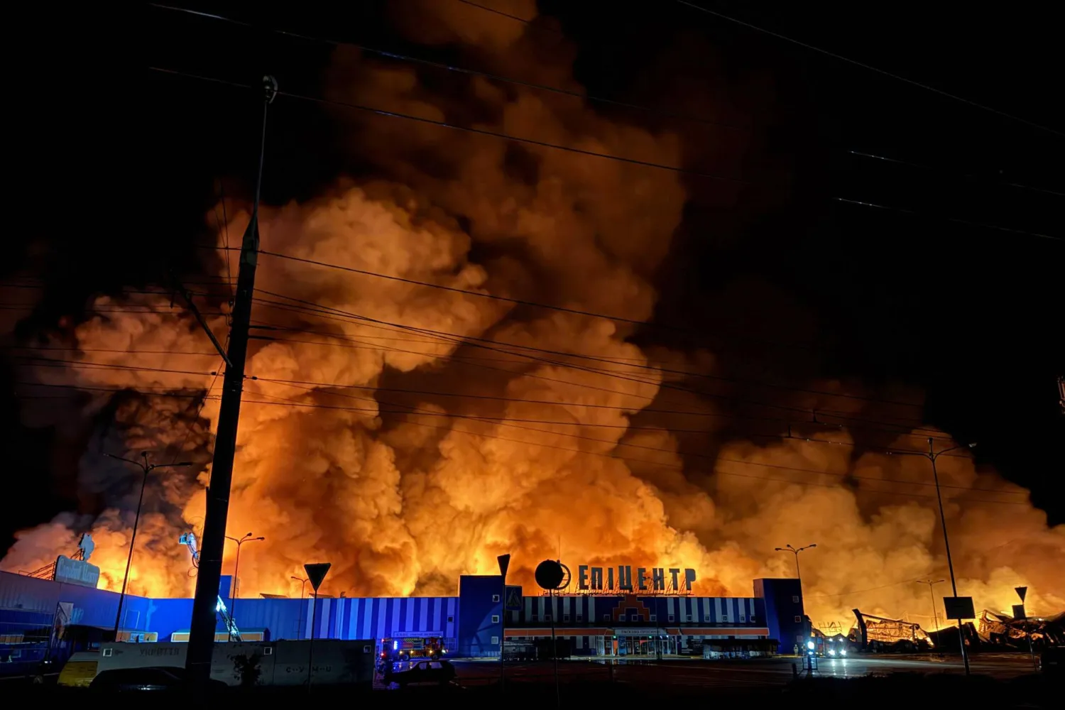 Ukraine's firefighters work to extinguish a fire at the site of a drone strike on a shopping center in Sumy late at night on July 20, 2026, amid the Russian invasion of Ukraine. (Photo by Serhii Shapovalov (STR) / AFP)