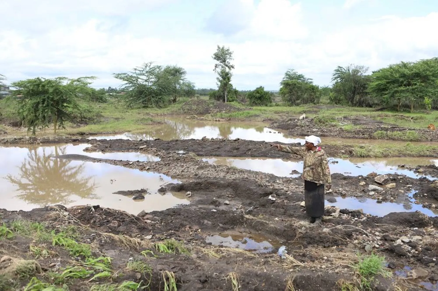 Martha Waema, stands on her farm after it was submerged by weeks of rainfall in Machakos, Kenya, May 8, 2024. (AP)