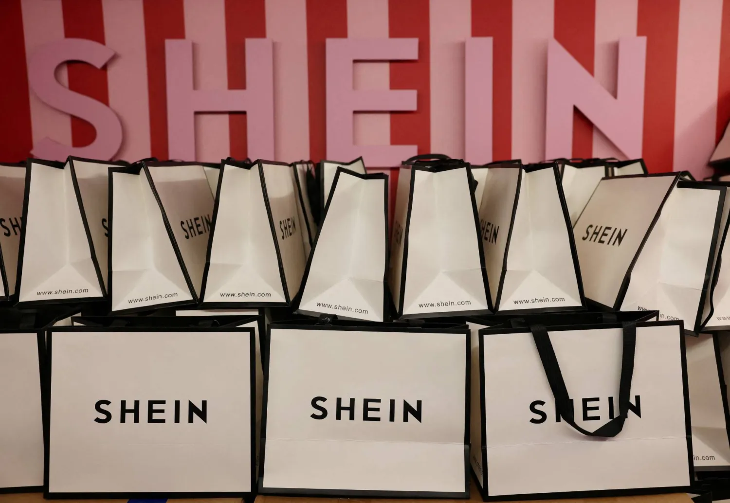 FILE PHOTO: A company logo for fashion brand Shein is seen on a pile of gift bags on its Christmas bus as part of a nationwide promotional tour in Liverpool, Britain, December 14, 2024. REUTERS/Phil Noble/File Photo