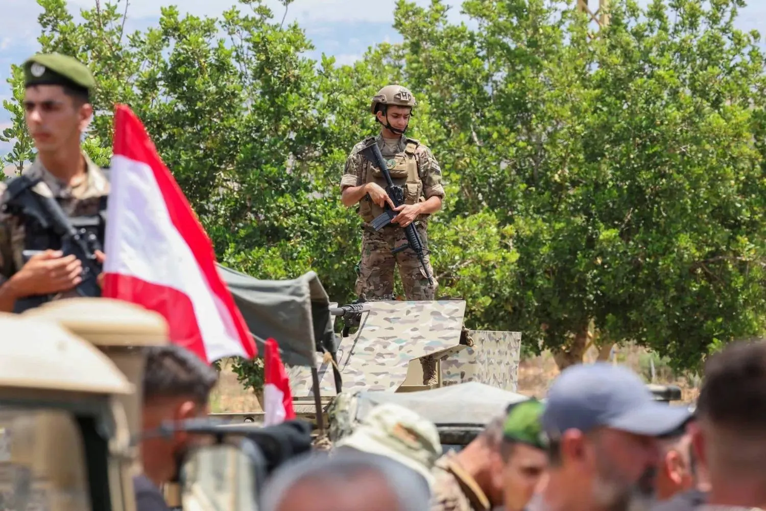 Lebanese soldiers ride military vehicles at the entrance to Zawtar al-Gharbiyeh, where the army deployed on Tuesday after an Israeli withdrawal. (Reuters)