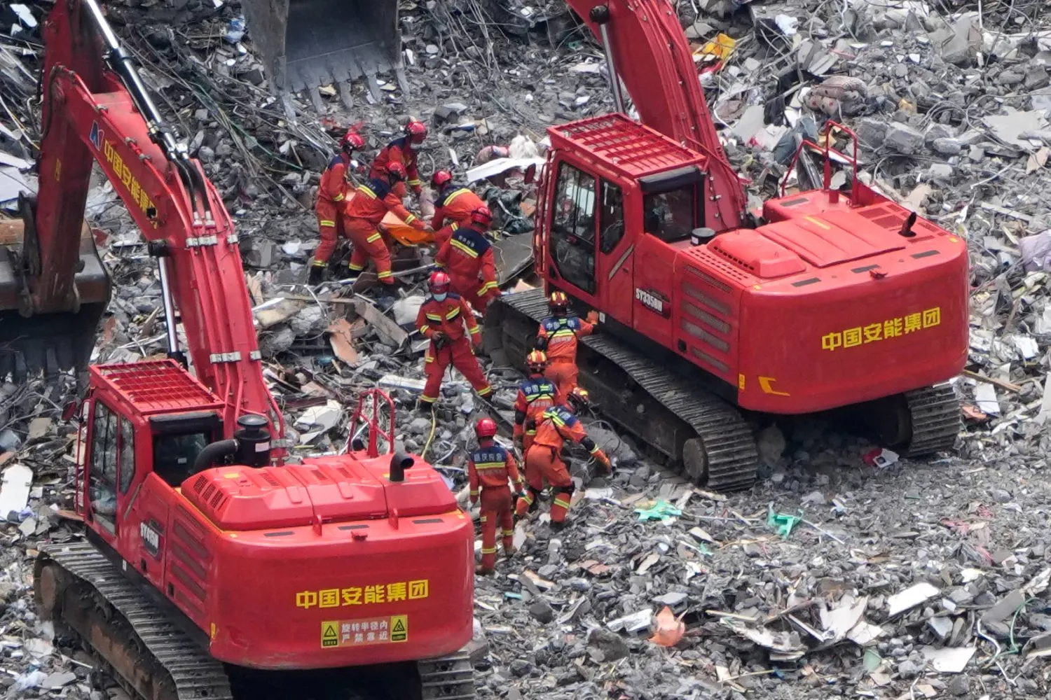 Rescuers recover a trapped victim from the rubble at the scene of a landslide in Pengshui County in southwestern China's Chongqing area on Sunday, July 19, 2026. (AP Photo/Andy Wong)