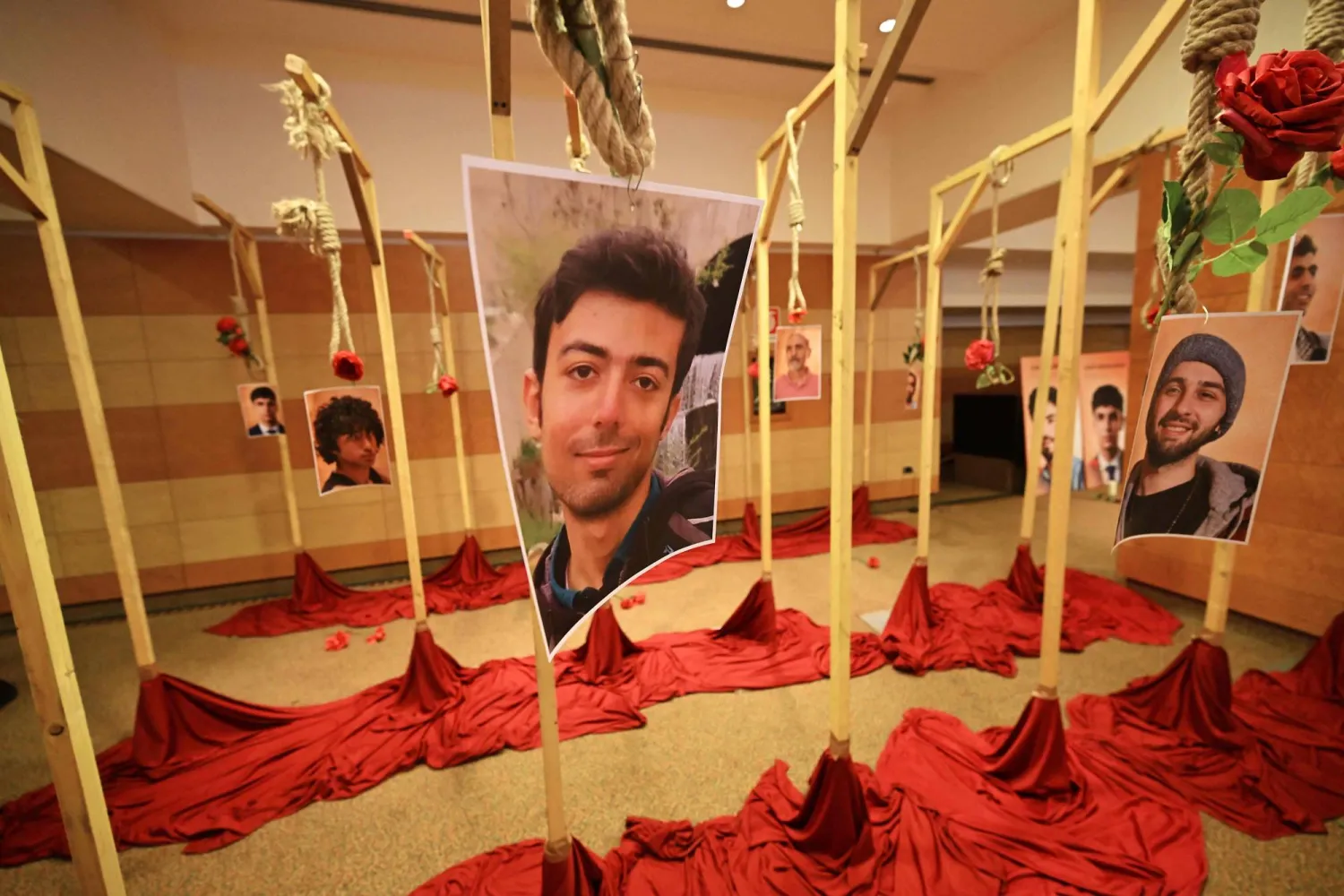 This photograph shows portraits of Iranian protesters allegedly executed by the Iranian regime during protests in Iran are displayed during a demonstration at the Ergife Palace Hotel to condemn the silence of Western governments in the face of the growing wave of Iranian political executions, in Rome on July 16, 2026. (AFP) 
