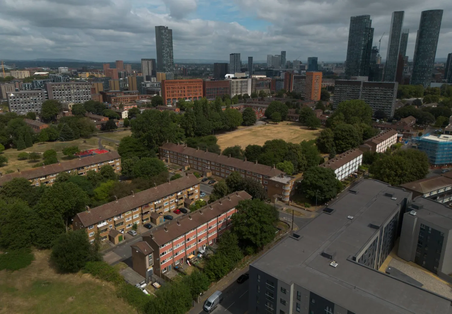 An aerial photograph taken with a drone shows high-rise towers behind social housing blocks in Manchester, Britain, 23 July 2026.  EPA/ADAM VAUGHAN