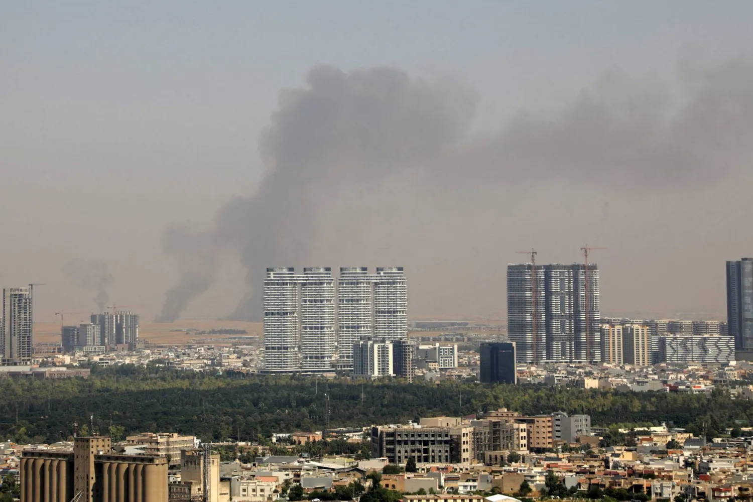 Smoke rises after explosions were heard and air defenses activated near the airport in Erbil, on July 24, 2026. (Photo by AFP) 
