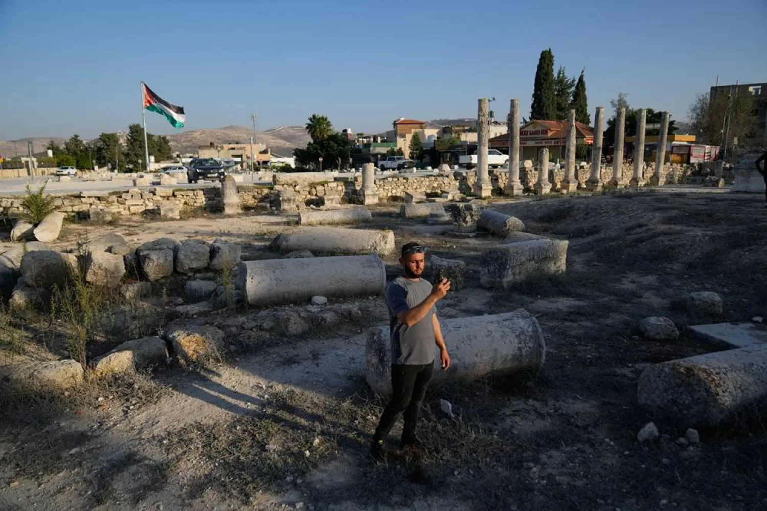 A Palestinian visitor takes a photo at the Roman historical site in the West Bank town of Sebastia, Thursday, Nov. 20, 2025. (AP)