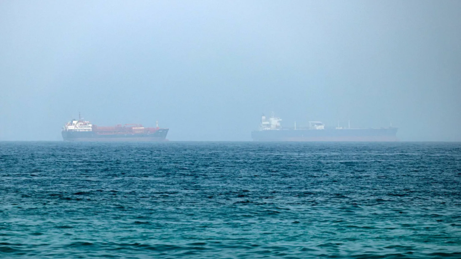 Cargo vessels are seen at one end of the Strait of Hormuz near the coast of Dibba Al Fujairah, United Arab Emirates, 21 July 2026.  EPA/STRINGER