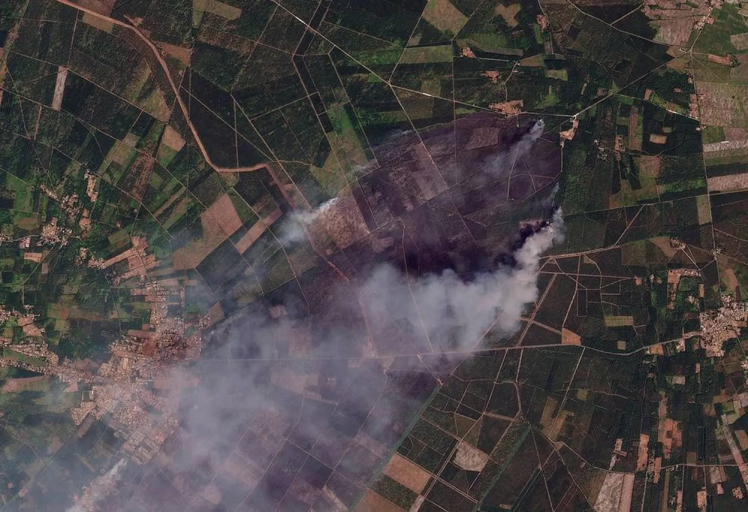 Satellite imagery shows burned areas and smoke rising from a wildfire, near Le Porge, in Nouvelle-Aquitaine, France July 23, 2026. 2026 (Planet Labs PBC/Handout via Reuters)