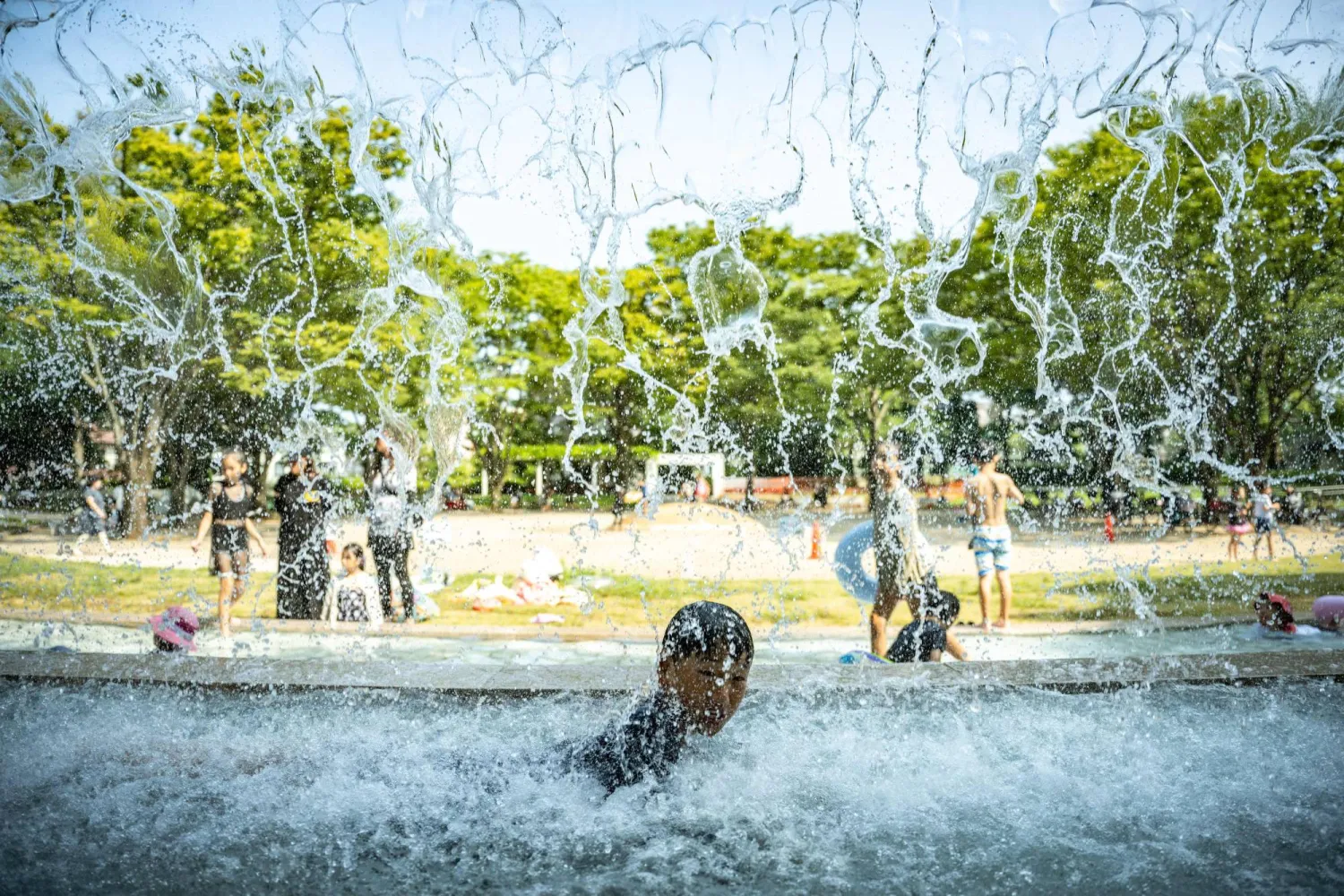  A child cools off in a public water playground at a park in Edogawa district of Tokyo on July 23, 2026. (AFP) 
