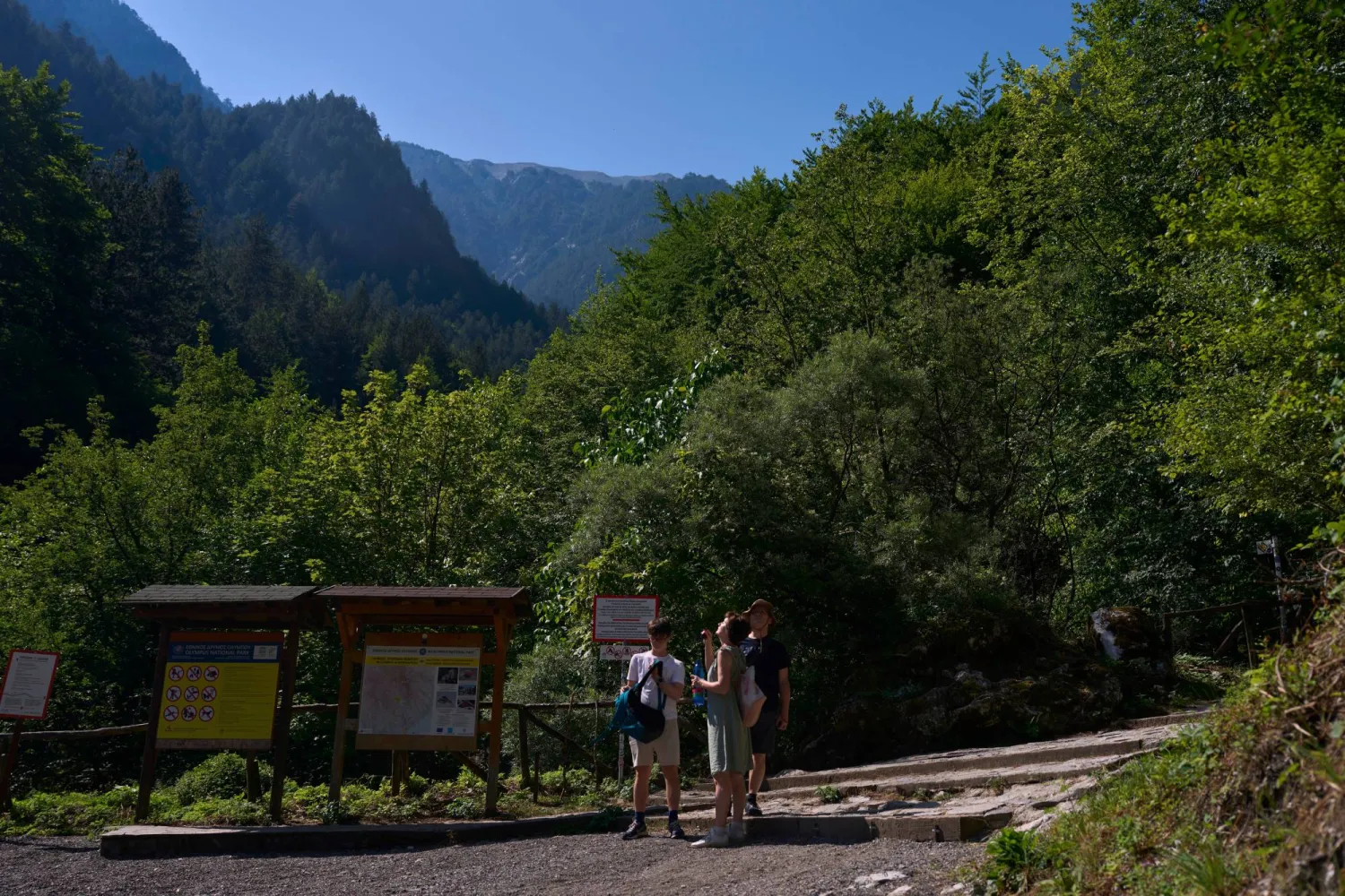 Visitors stand at the Prionia trailhead on Mount Olympus in northern Greece, Wednesday, July 15, 2026. (AP Photo/Petros Giannakouris)