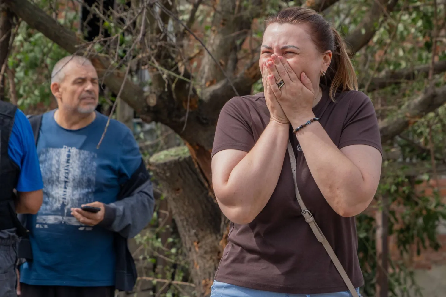 People react after a Russian drone attack hit a private house in Kharkiv, Ukraine, Sunday, July 26, 2026. (AP Photo/Andrii Marienko)