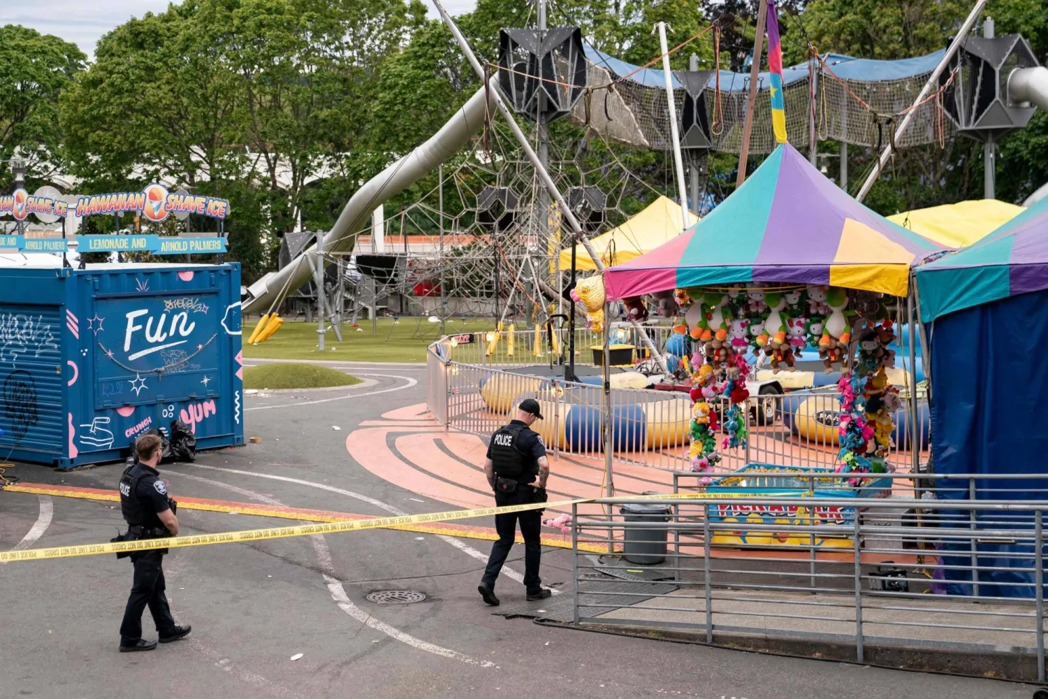 SEATTLE, WASHINGTON - JULY 26: Police officers walk on patrol at the scene of a mass shooting at the Bite of Seattle food festival on July 26, 2026 in Seattle, Washington. David Ryder/Getty Images/AFP