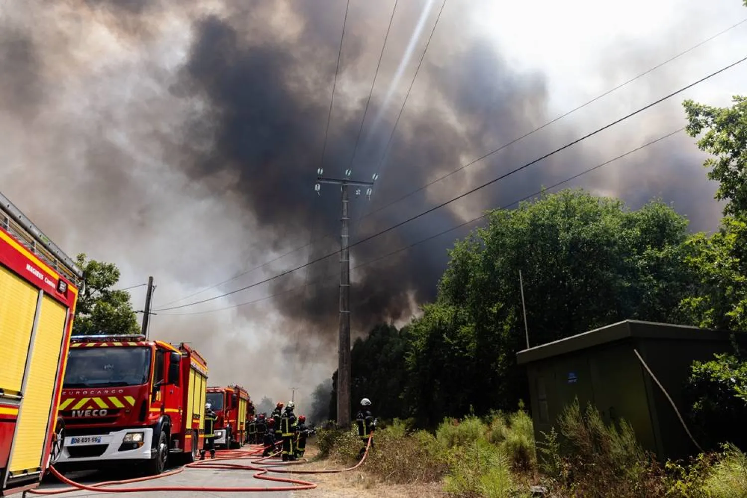 French firefighters battle a wildfire spreading in Cestas-Perroton, south-western France, 26 July 2026. (EPA)