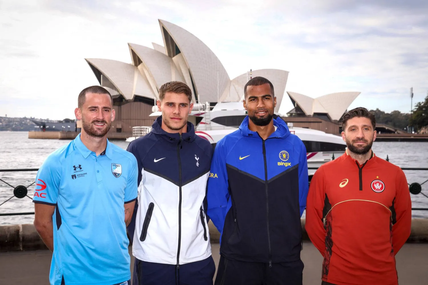 English Premier League football club Tottenham Hotspur's Micky van de Ven (2nd L) and Chelsea's Robert Sanchez (2nd R) pose with Australian A-League players Sydney FC's Jordan Courtney-Perkins (L) and Western Sydney Wanderers FC's Brandon Borrello (R) during an official event in front of the Sydney Opera House on July 27, 2026. (AFP)