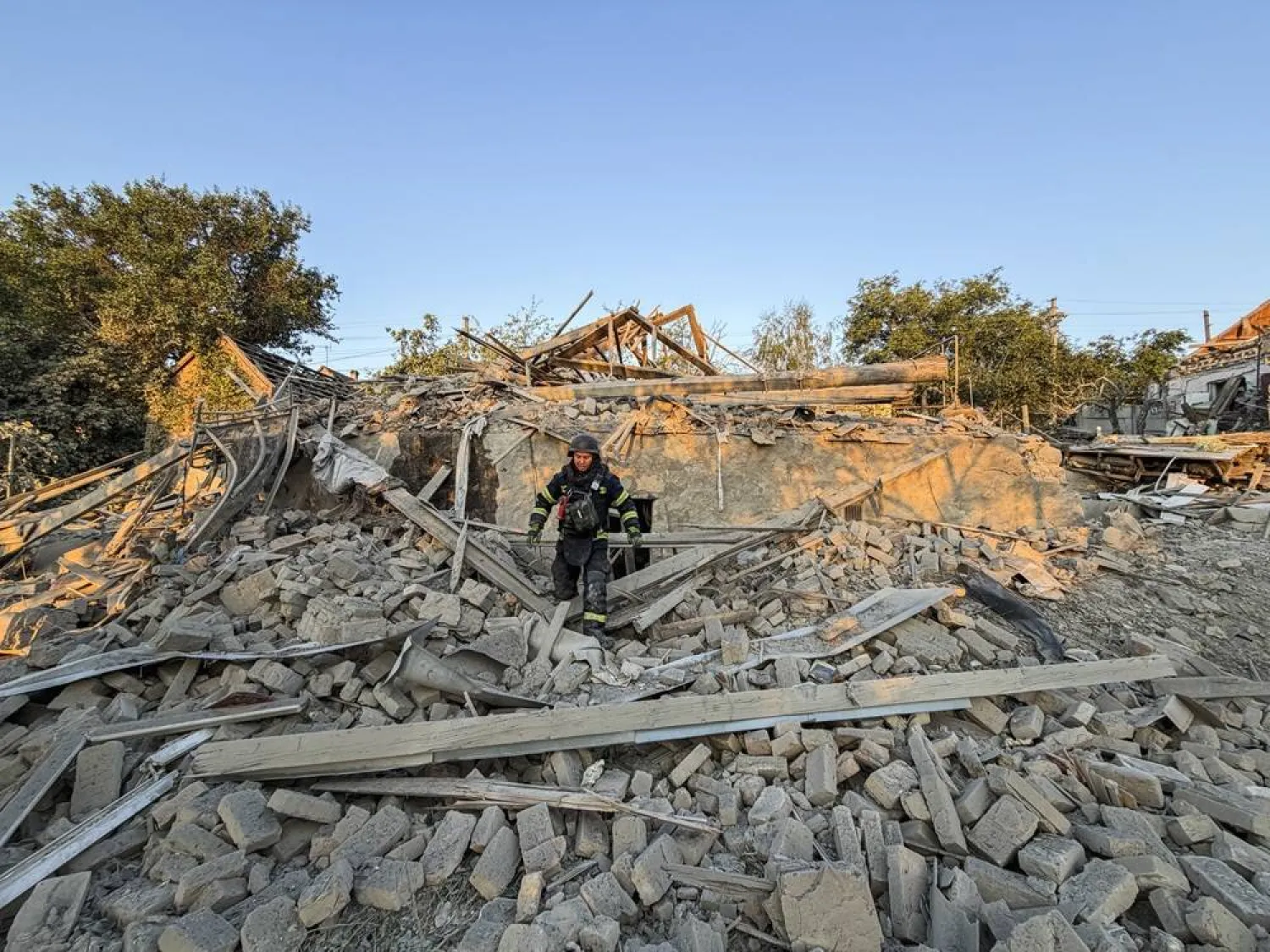 Ukrainian rescuers work at the site of a Russian attack on a building in Zaporizhzhia, Ukraine, 27 July 2026, amid the ongoing Russian invasion. (EPA)