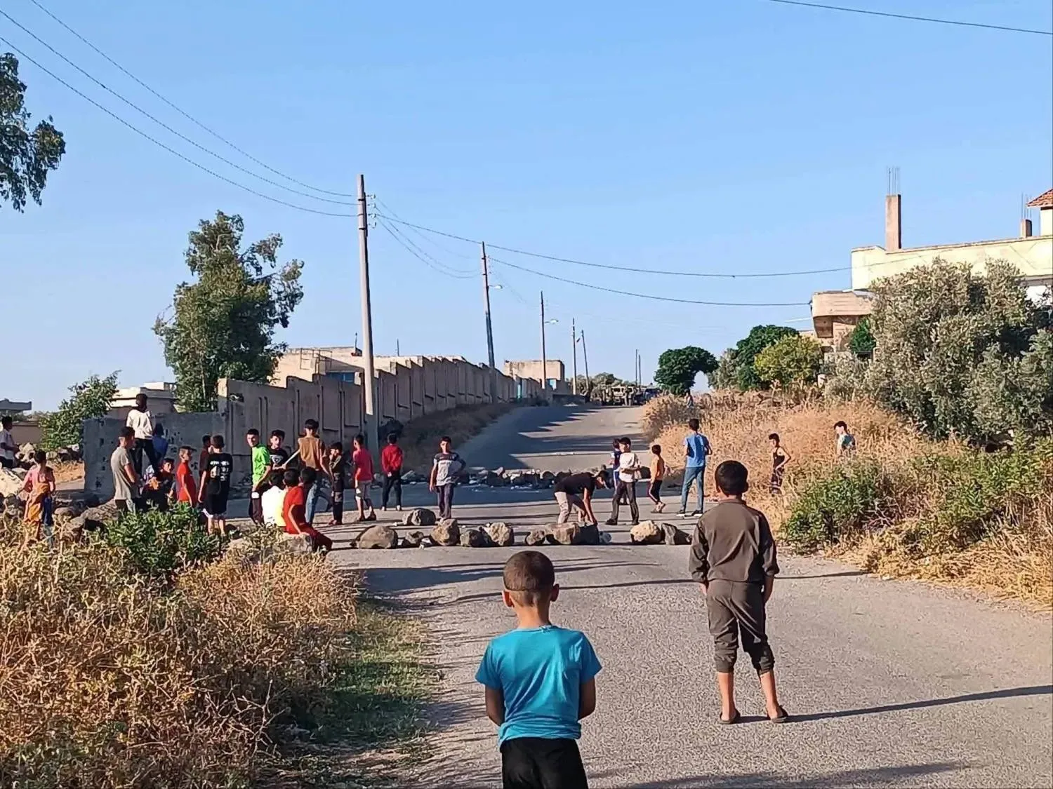 Children block a road in the Yarmouk Basin area in southern Syria in an attempt to prevent an Israeli patrol from entering the area. (Facebook) 