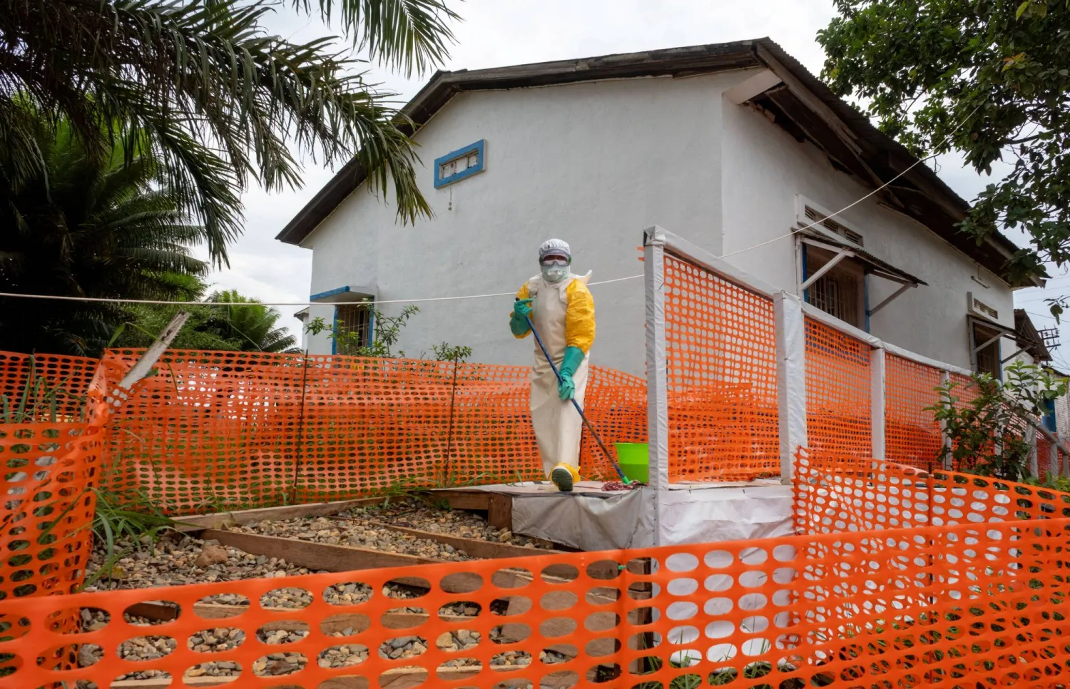 A Congolese health worker cleans outside her station during the tour by Democratic Republic of Congo Prime Minister Judith Suminwa Tuluka, at the Mongbwalu General Hospital in the Ebola-stricken town of Mongbwalu, July 24, 2026. (Reuters)