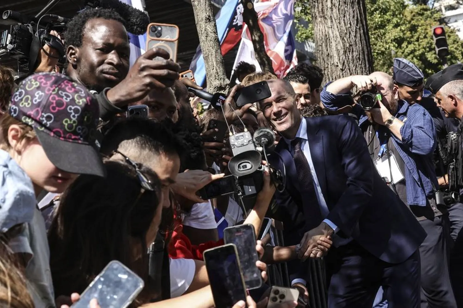 New head coach of the French men's national football team Zinedine Zidane meets supporters next to the French Soccer federation's headquarters in Paris, France, 28 July 2026. (EPA)