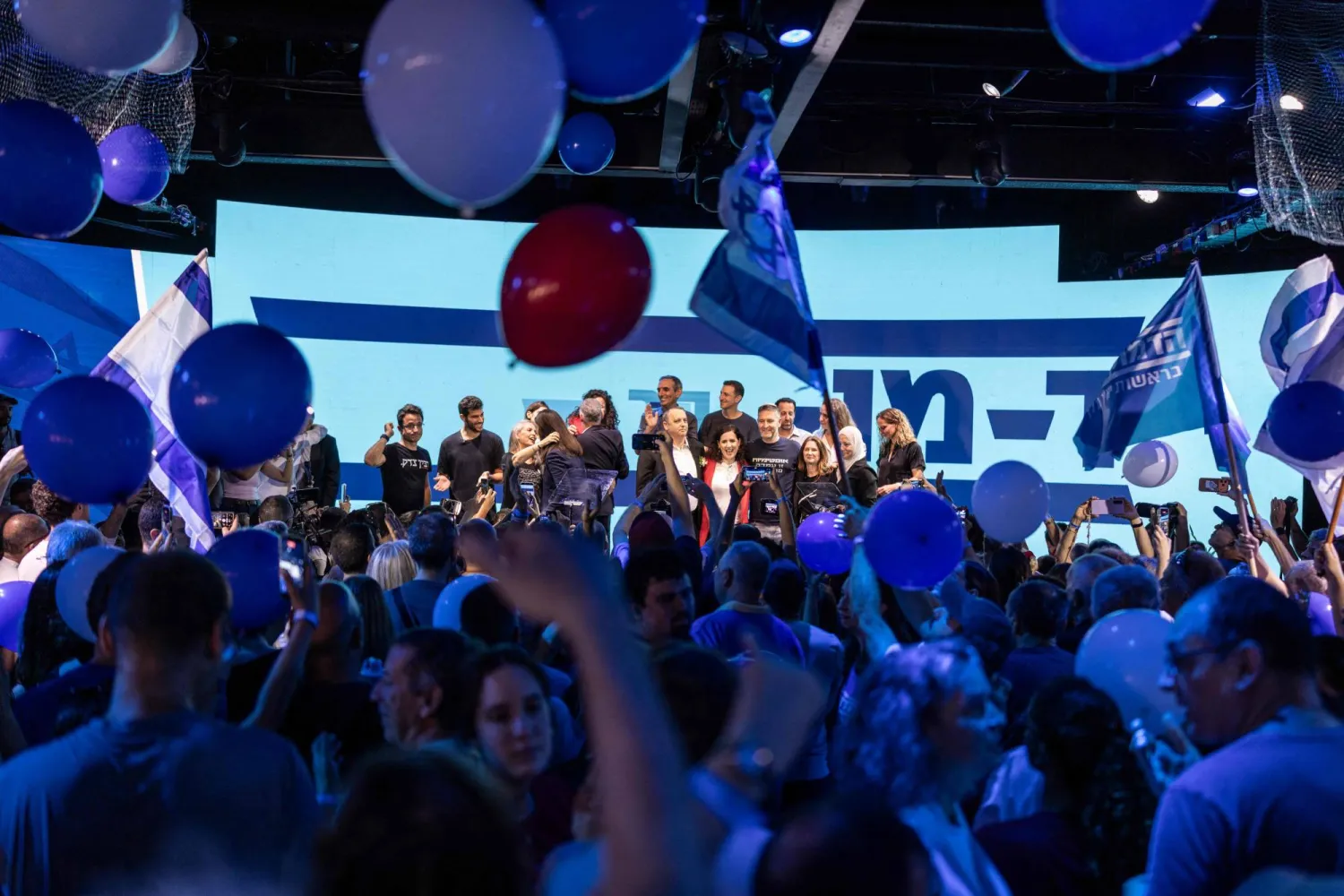 Party members stand on stage during the HaDemokratim ("The Democrats") party's campaign launch rally following its primaries ahead of the country's general elections in Tel Aviv on July 20, 2026. (AFP)