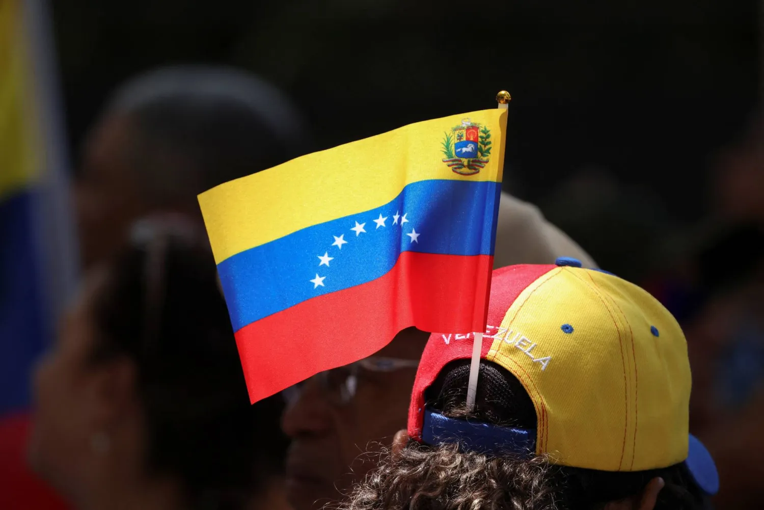 A supporter of opposition leader Maria Corina Machado’s Vente Venezuela wears a Venezuelan flag during a rally marking the two-year anniversary of presidential elections, which authorities said Nicolas Maduro won, in Caracas, Venezuela, July 28, 2026. (Reuters)