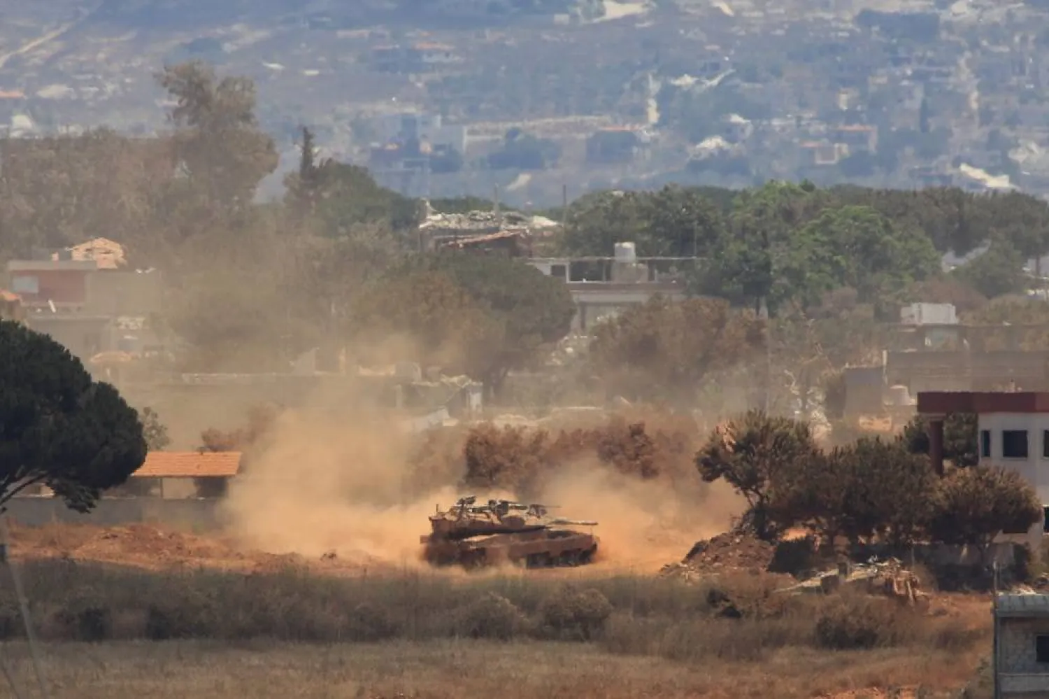 An Israeli tank drives through Zawtar al-Sharqieh village, occupied by Israeli forces, as seen from the southern village of Zawtar al-Gharbieh, Lebanon, Monday, July 27, 2026. (AP) 