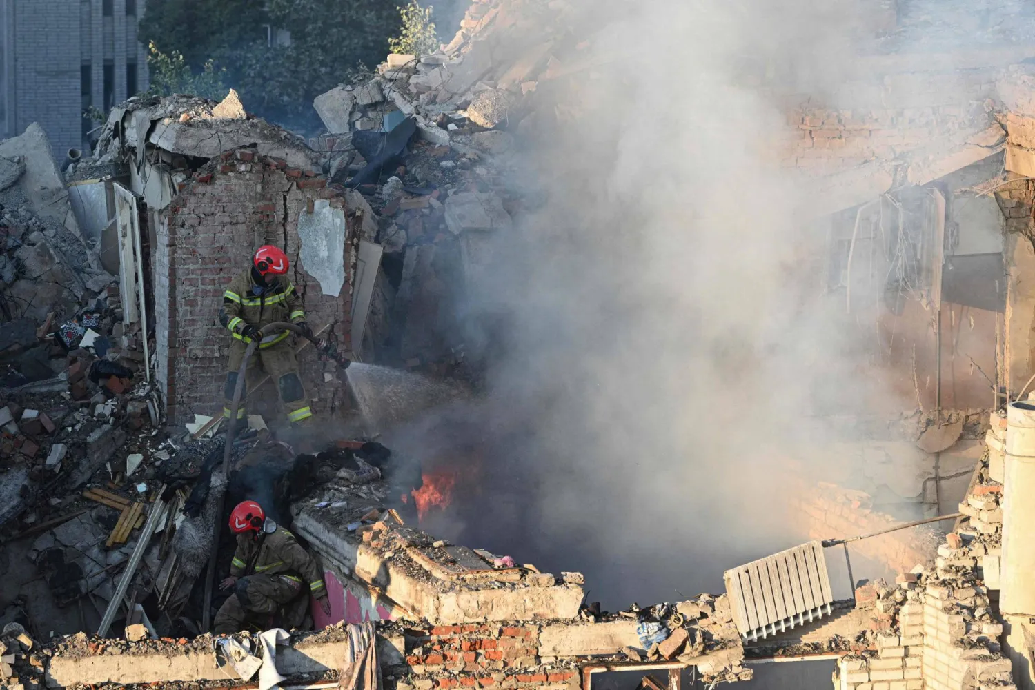TOPSHOT - First responders operate at a residential building partially destroyed as a result of Russian missile strikes in the western Ukrainian city of Lviv on July 30, 2026, amid the Russian invasion in Ukraine. (Photo by YURIY DYACHYSHYN / AFP)