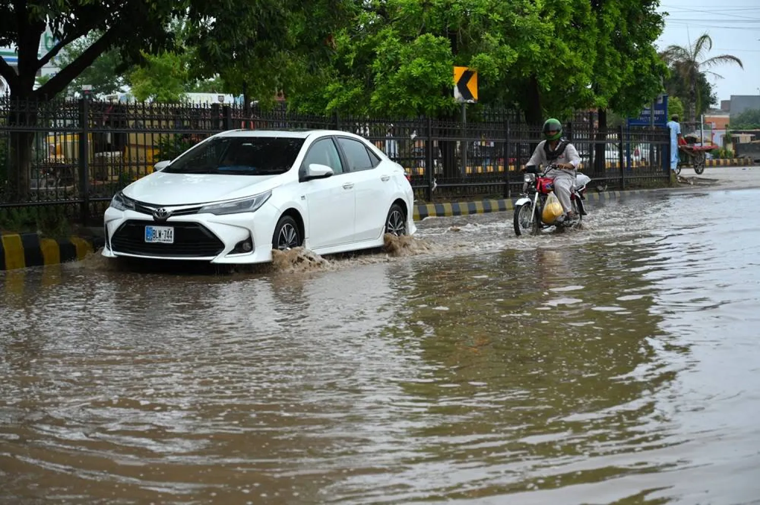 Vehicles drive along a waterlogged road following heavy monsoon rains in Peshawar, Pakistan, 22 July 2026. (EPA)