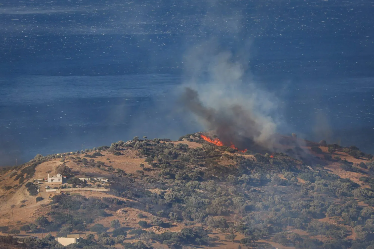 Smoke rises during a wildfire, south of Rethymno in the Greek island of Crete on July 30, 2026. (AFP)