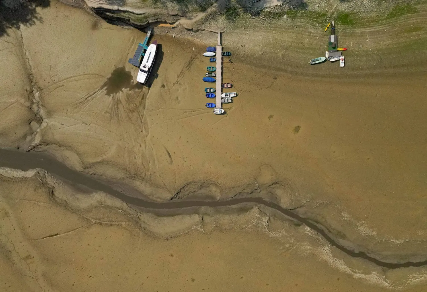  A drone view shows moored boats on the nearly empty Lake Brenets as drought conditions affecting the Doubs River lower water levels along the Swiss-French border in Les Brenets, Switzerland, July 30, 2026. (Reuters)