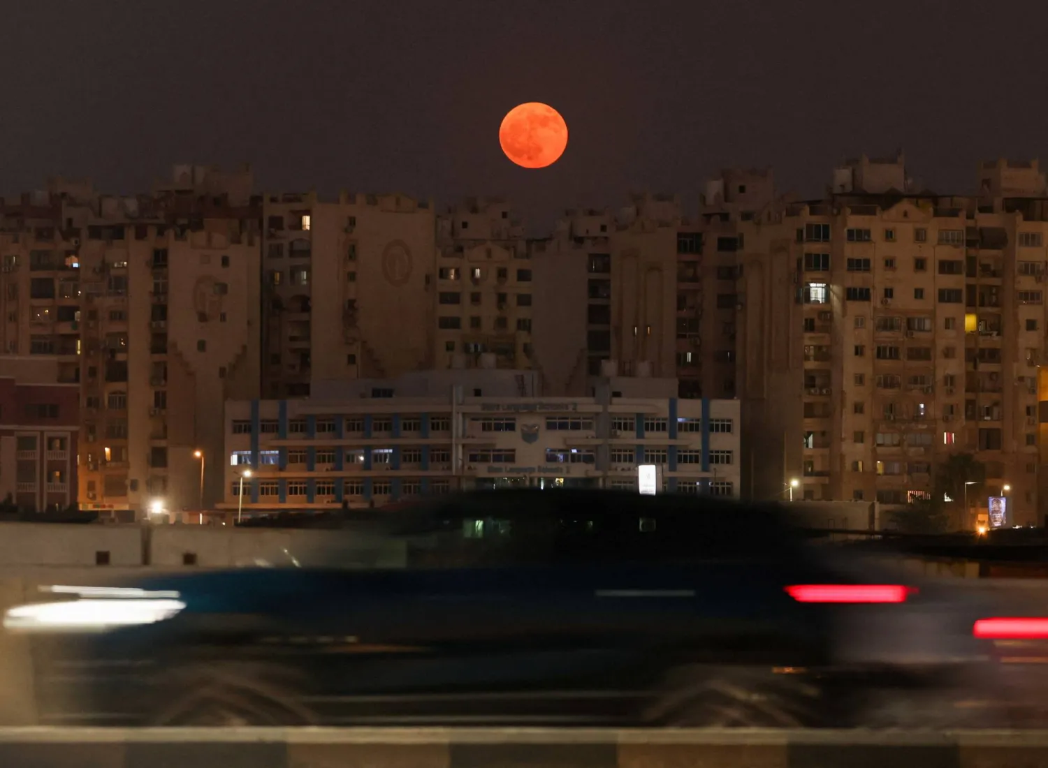 The full moon known as the "Buck Moon" rises over residential buildings in the capital city of Cairo, Egypt, July 29, 2026. (Reuters) 
